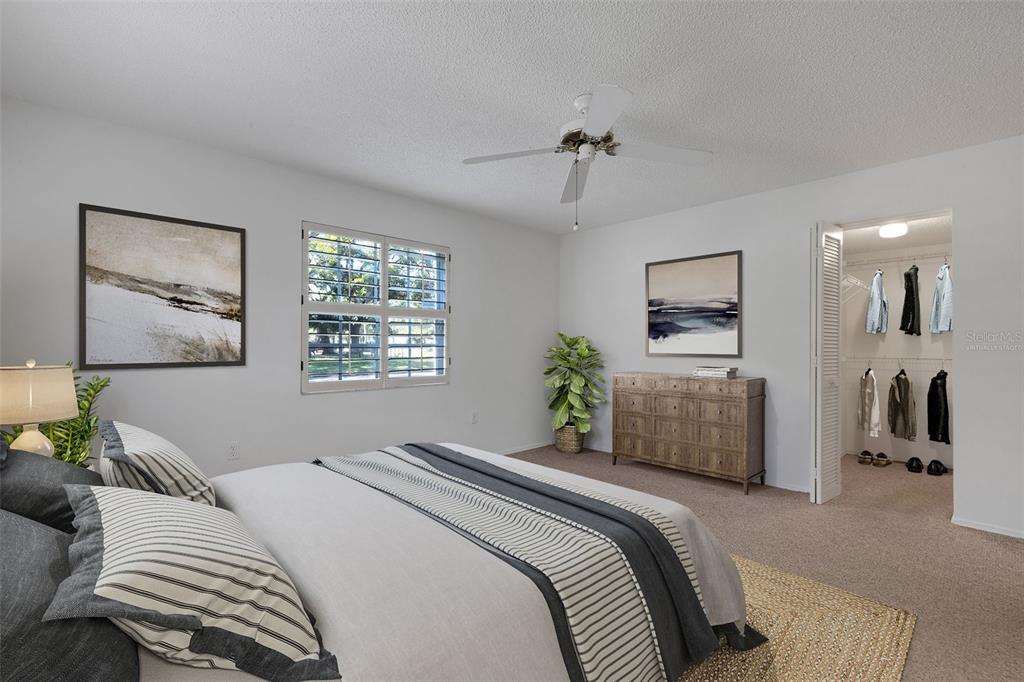 A bedroom features a bed, a dresser, a window with shutters, and an open closet — 528 W VENICE AVENUE UNIT # 1, VENICE, FL