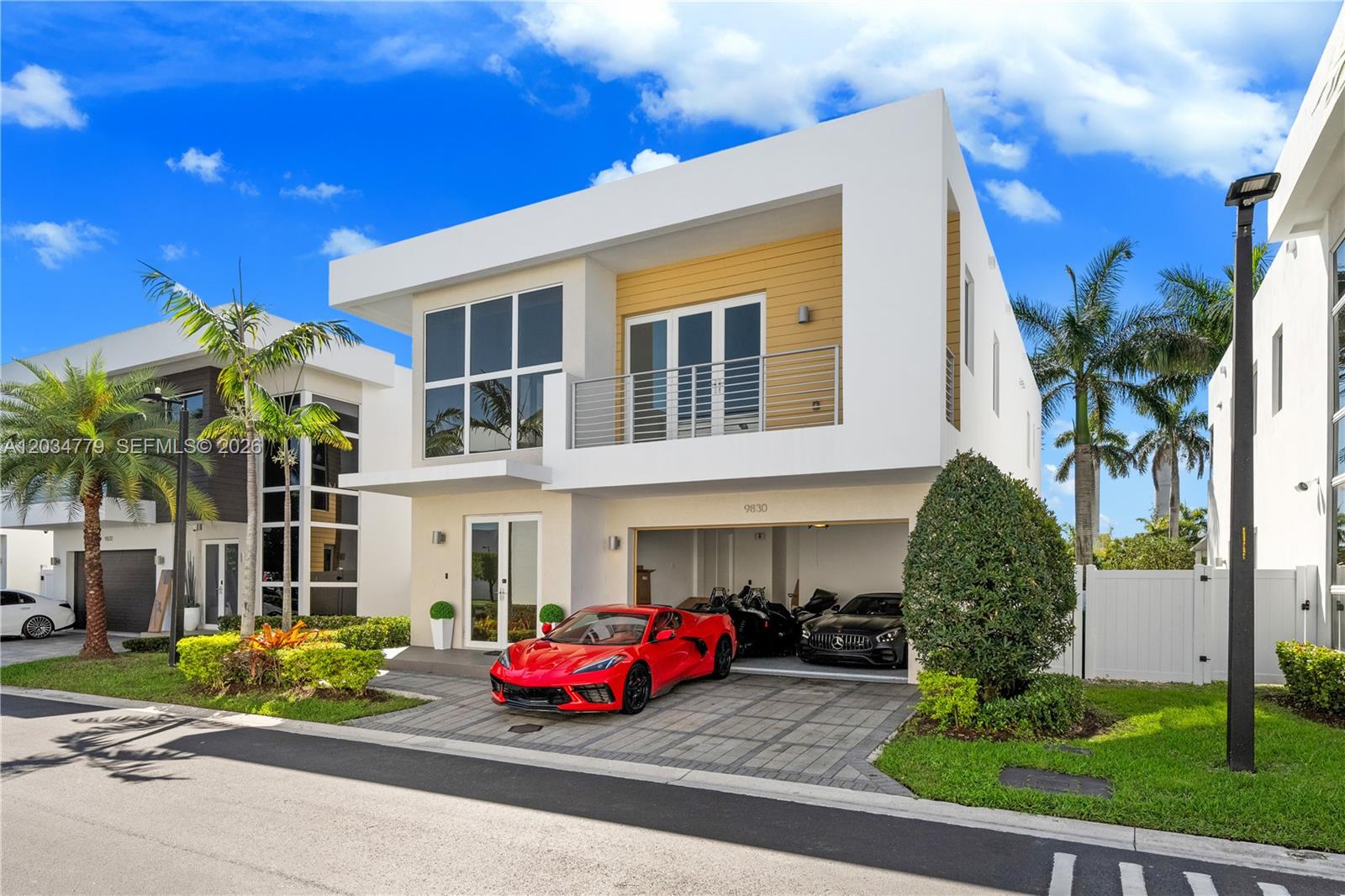 A modern two-story house features a red sports car parked in the driveway — 9830 NW 74th Ter, Doral FL 33178, DORAL, FL