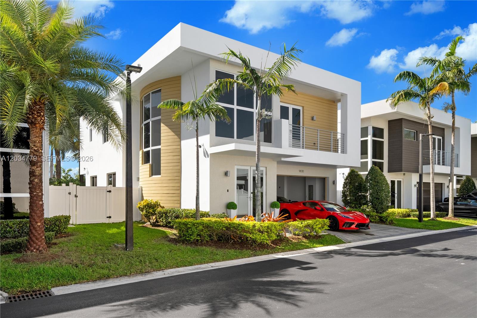 A modern two-story house features a white exterior, a red sports car, and palm trees — 9830 NW 74th Ter, Doral FL 33178, DORAL, FL