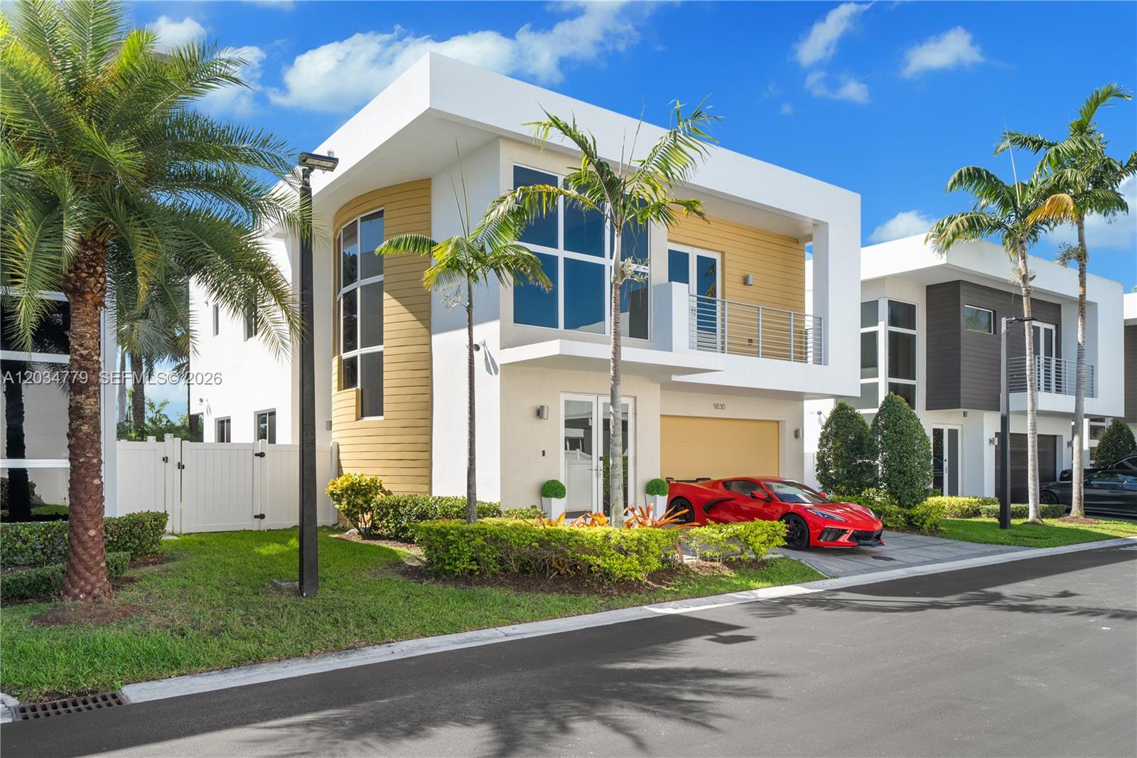 A modern two-story house with a red sports car parked in the driveway — 9830 NW 74th Ter, Doral FL 33178, DORAL, FL