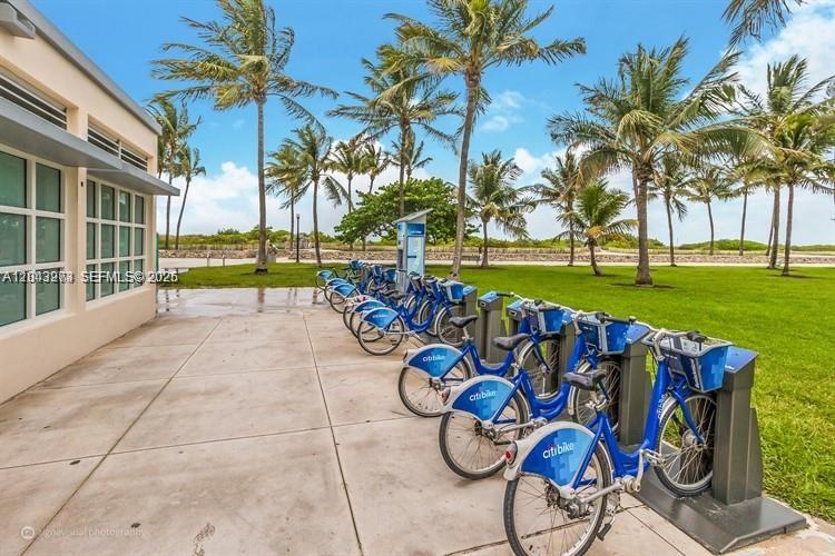 A row of blue Citi Bike rental bicycles is parked on a concrete patio outdoors — 1618 Michigan Ave # 38, Miami Beach FL 33139, MIAMI BEACH, FL