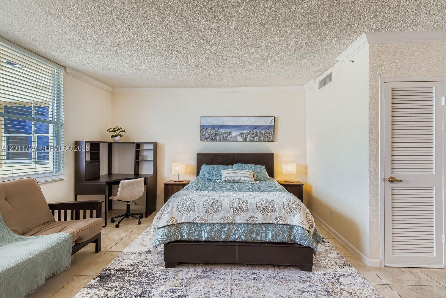 A bedroom features a bed, a desk, a chair, and a window with blinds — 2501 S Ocean Dr # 1032, Hollywood FL 33019, HOLLYWOOD, FL