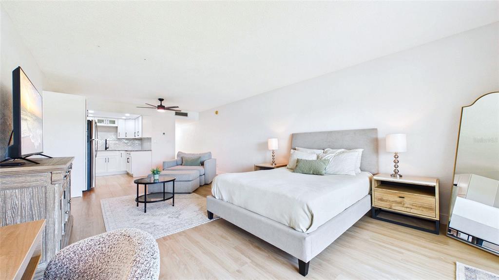 A studio apartment features a bed, a small seating area, and an open kitchen — 3789 46TH AVENUE S UNIT 204, ST PETERSBURG, FL