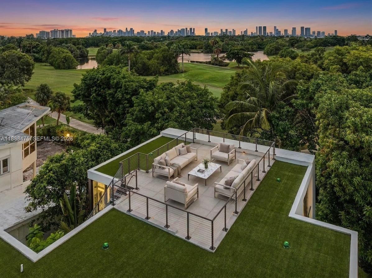 An aerial view of a rooftop terrace with outdoor furniture overlooking a golf course — 3114 Prairie Ave, Miami Beach FL 33140, MIAMI BEACH, FL