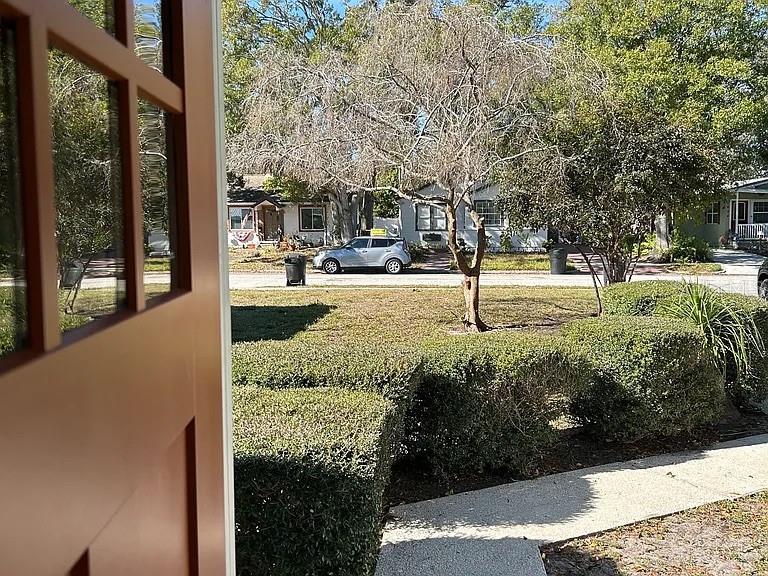 A view from a doorway looking out at a suburban street with a parked car — 3027 MELTON STREET N, ST PETERSBURG, FL