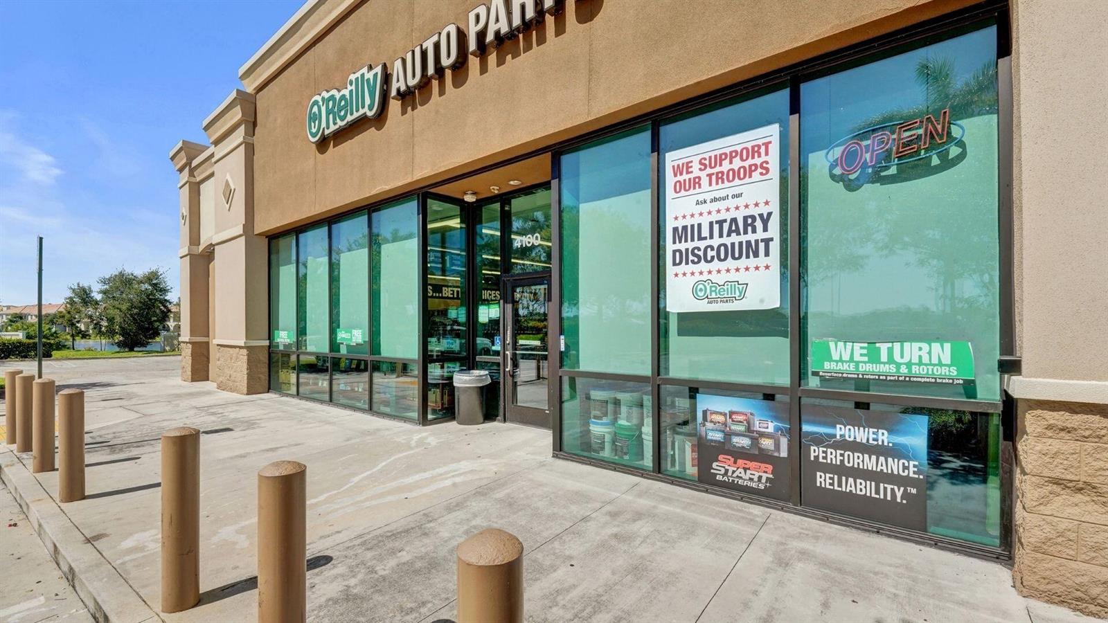 The exterior of an O'Reilly Auto Parts store features large glass windows and concrete bollards — 4100 N University Drive, Cooper City FL 33024, COOPER CITY, FL