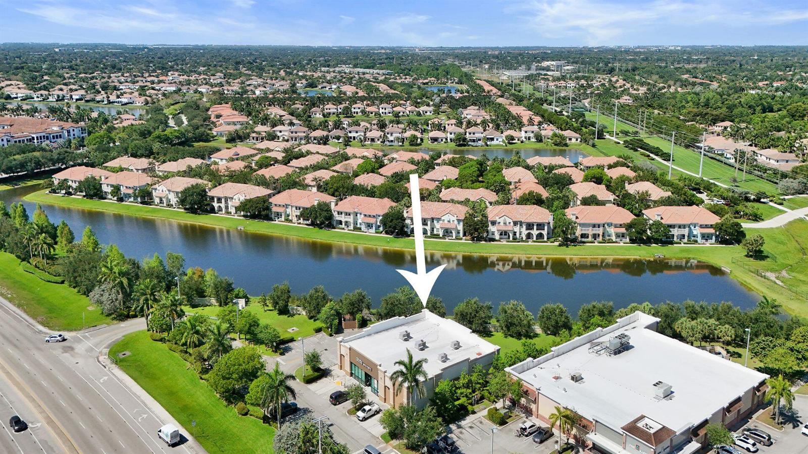 An aerial view shows a commercial building with a white arrow pointing to its roof — 4100 N University Drive, Cooper City FL 33024, COOPER CITY, FL