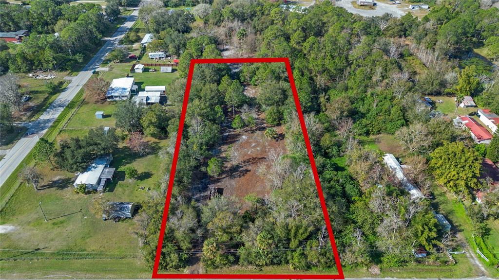 An aerial view shows a rectangular, wooded lot outlined in red between two roads — 1520 8TH STREET, ORLANDO, FL