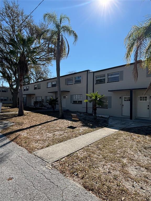 A two-story apartment building with palm trees and a concrete walkway in front — 11916 133RD AVENUE, LARGO, FL