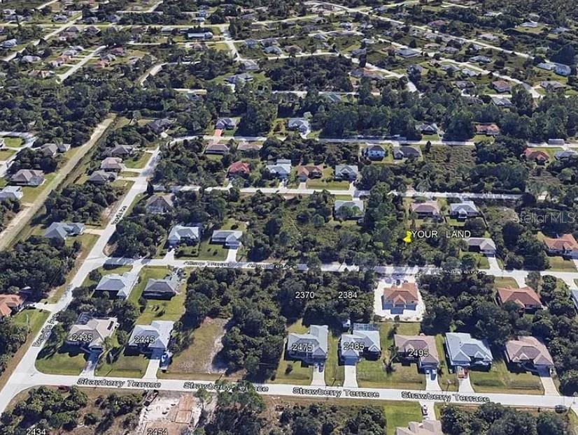 This is an aerial view of a residential neighborhood showing a vacant lot marked as land — Lot 38 ALLSUP TERRACE, NORTH PORT, FL