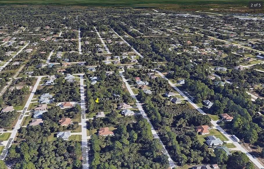 An aerial view shows a vacant, wooded residential lot marked with a yellow pin — Lot 38 ALLSUP TERRACE, NORTH PORT, FL