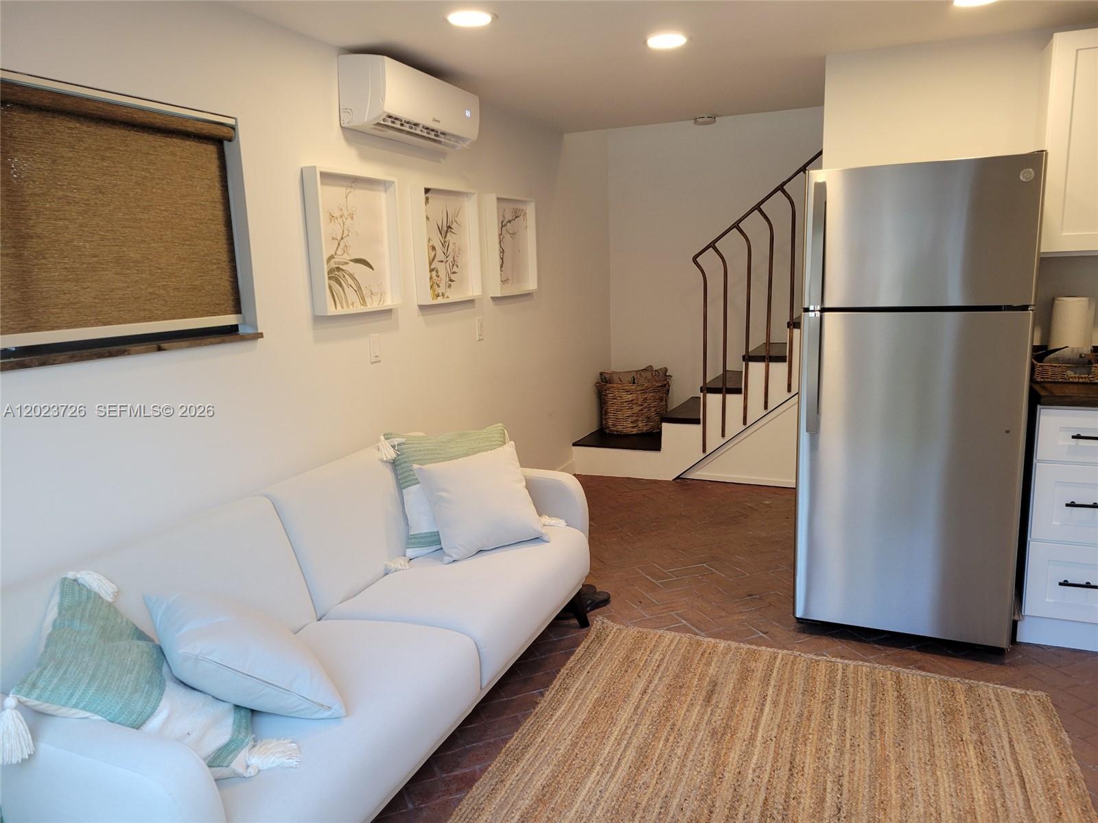 A living room features a white sofa, a stainless steel refrigerator, and a staircase — 5866 SW 60th St # 3, Miami FL 33143, MIAMI, FL