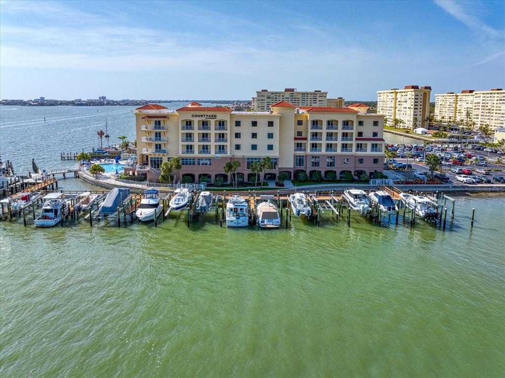 An aerial view shows a waterfront hotel with a marina and docked boats — 601 AMERICAN LEGION DRIVE UNIT 16, ST PETERSBURG, FL
