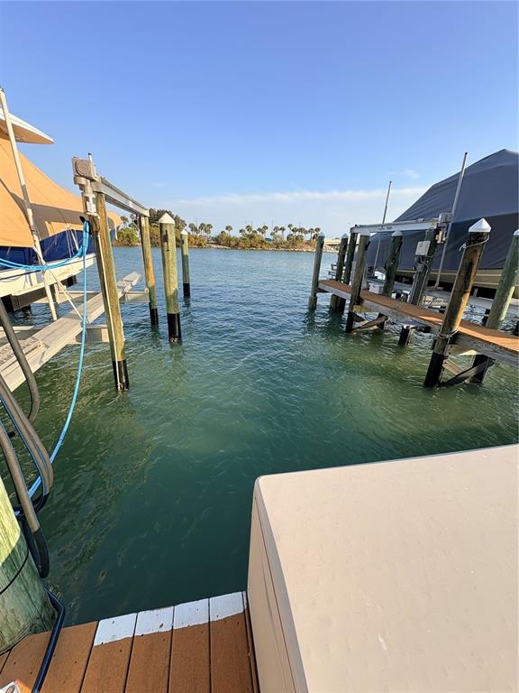 A view from a wooden dock looking out toward a canal with boat lifts — 601 AMERICAN LEGION DRIVE UNIT 16, ST PETERSBURG, FL