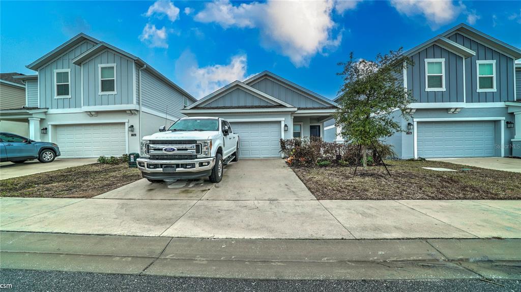 A white pickup truck is parked in the driveway of a suburban house — 1760 WHITE WATER COURT, DAVENPORT, FL