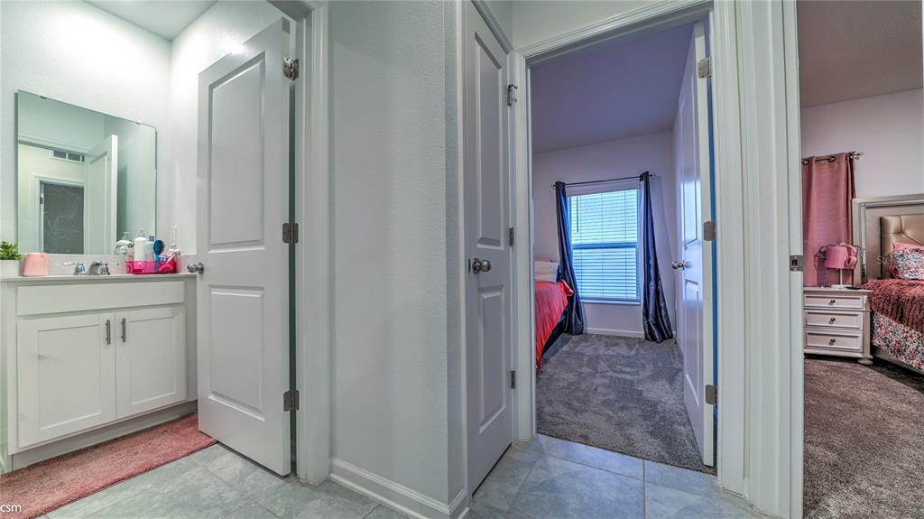 A hallway leads to a bathroom on the left and two bedrooms on the right — 1760 WHITE WATER COURT, DAVENPORT, FL