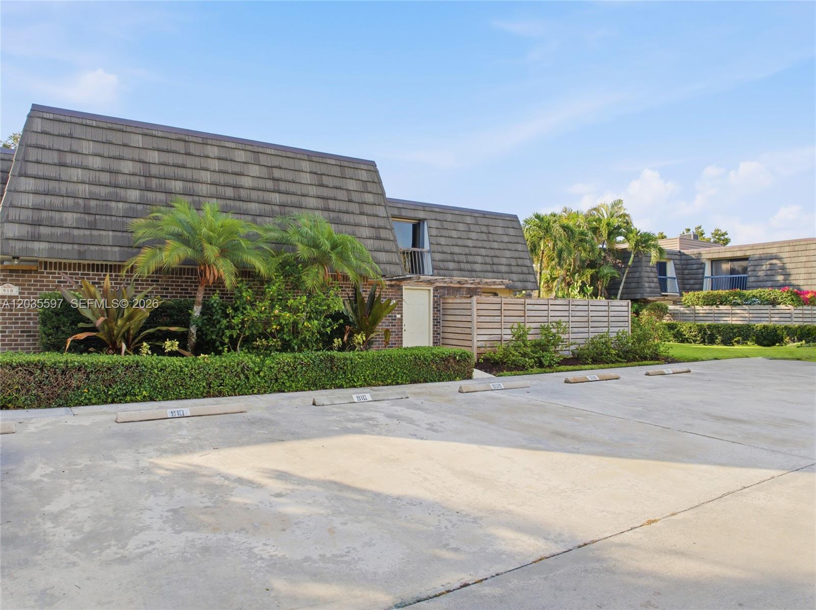 A two-story building with a mansard roof sits behind a paved parking lot — 909 9th Ter, Palm Beach Gardens FL 33418, PALM BEACH GARDENS, FL