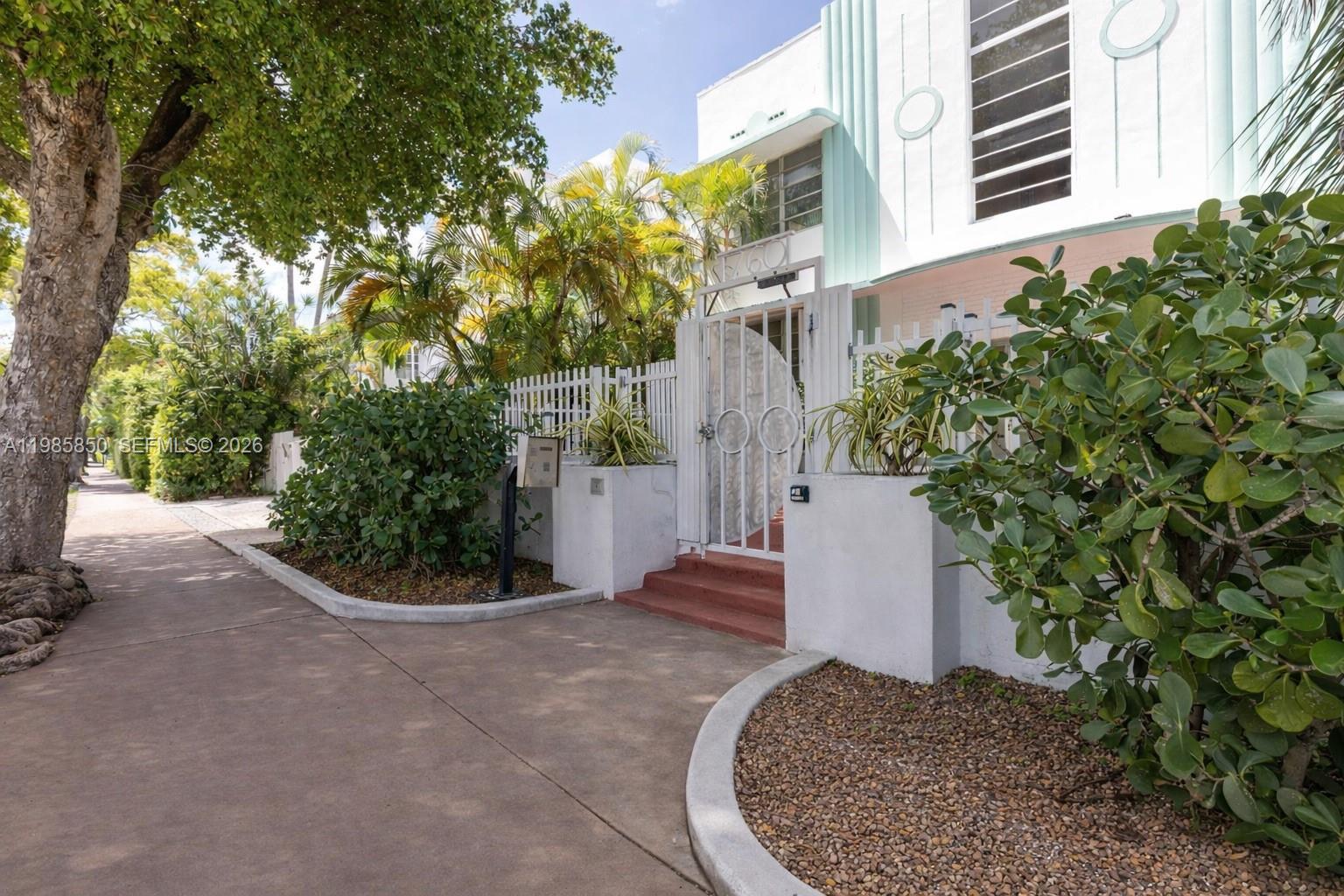 A white Art Deco building features a gated entrance with stairs and lush landscaping — 760 Jefferson Ave # 5, Miami Beach FL 33139, MIAMI BEACH, FL
