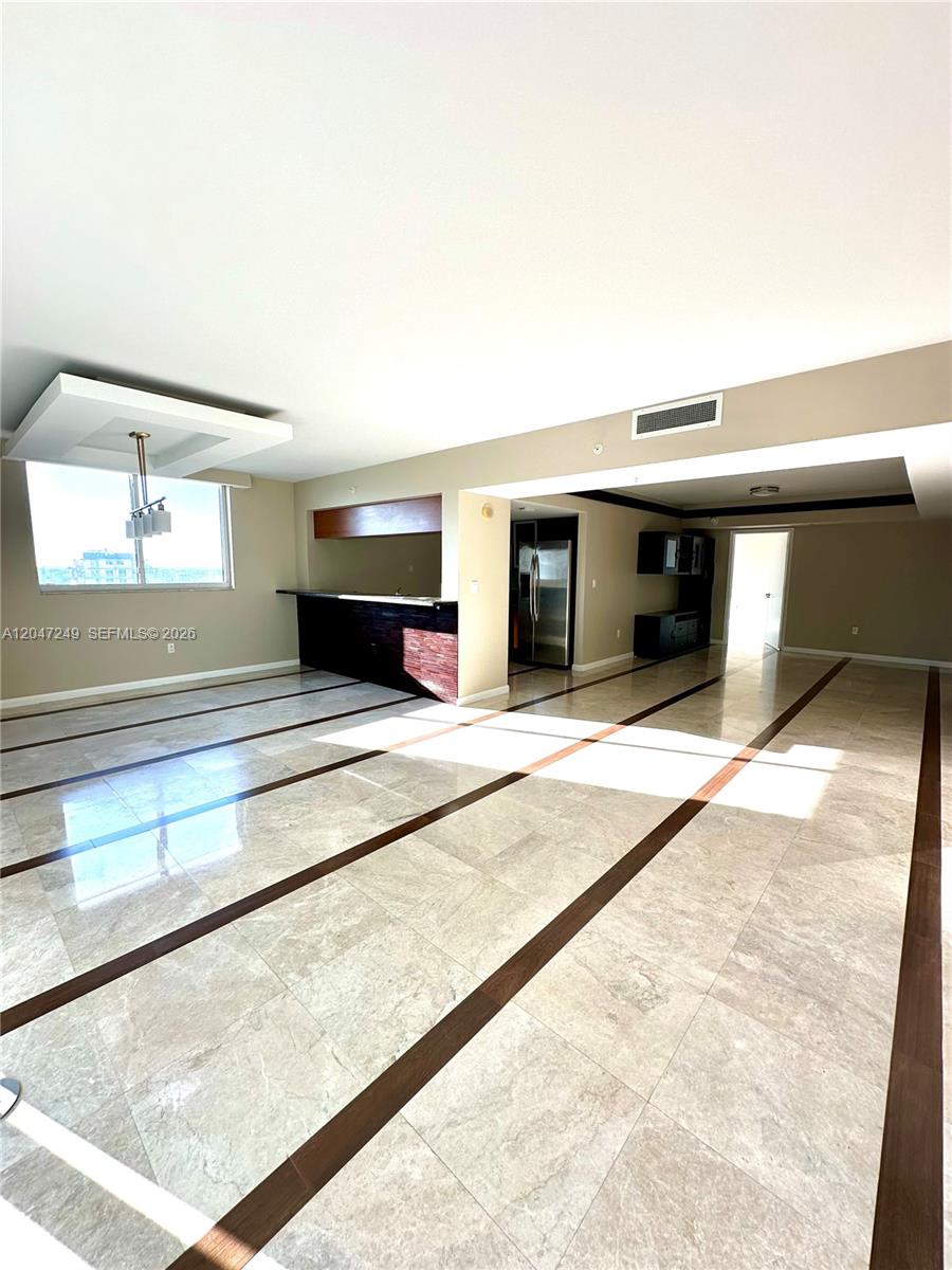 This open-concept living area features polished tile flooring with dark wood inlay accents — 1800 N Bayshore Dr # 2315, Miami FL 33132, MIAMI, FL