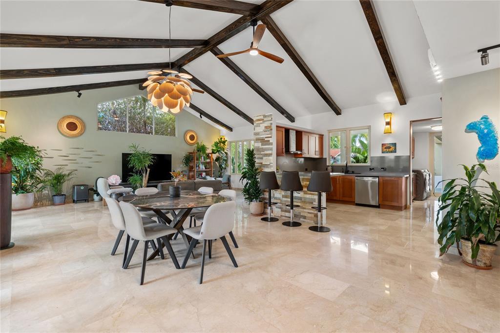 An open-concept living and dining area features vaulted ceilings with exposed beams and tile flooring — 319 CAMINO DEL GUAMA, DORADO, PR