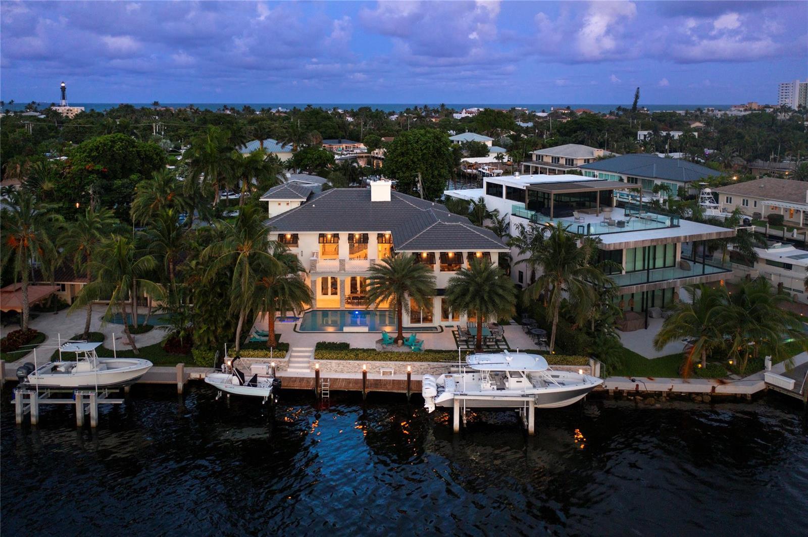 An aerial view of a waterfront home with a pool, dock, and two boats — 2307 N Riverside Drive, Pompano Beach FL 33062, POMPANO BEACH, FL