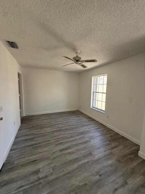 An empty room features white walls, a ceiling fan, and gray wood-look flooring — 314 Waterside Drive, Hypoluxo FL 33462, HYPOLUXO, FL