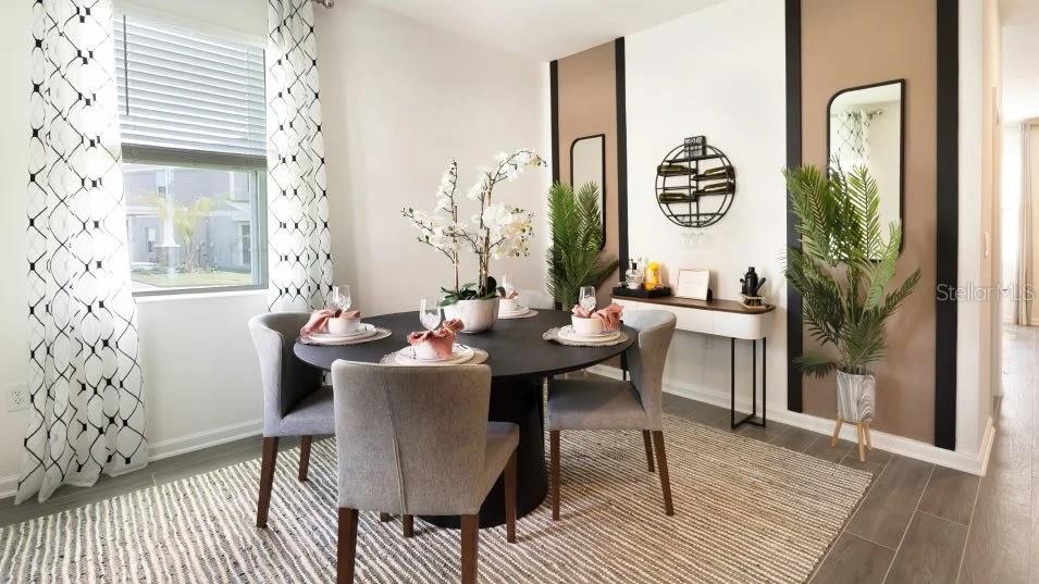 A dining room features a round black table, grey chairs, and decorative wall panels — 1955 STAKE OUT WAY, APOPKA, FL