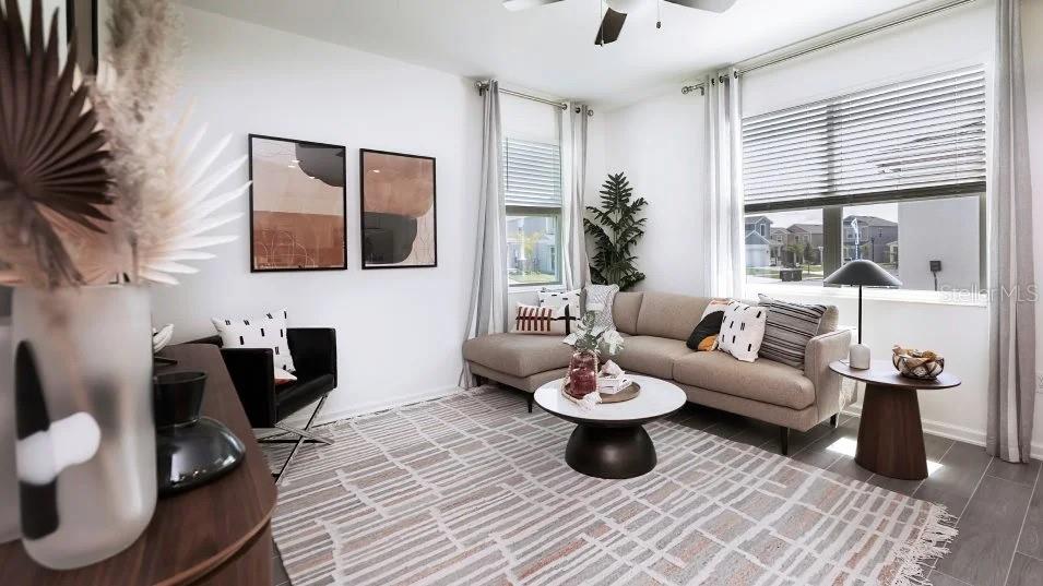 A living room features a beige sectional sofa, a round coffee table, and patterned area rug — 1955 STAKE OUT WAY, APOPKA, FL