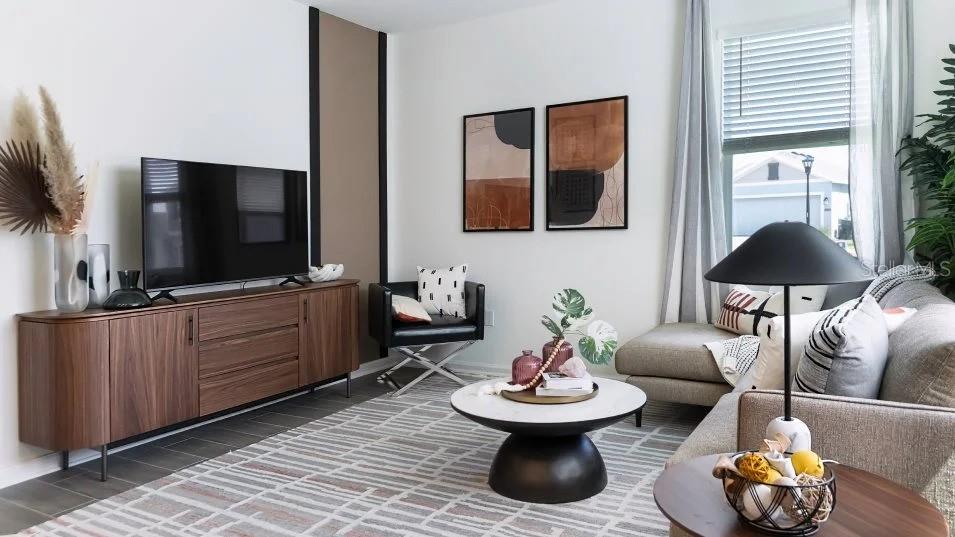 A modern living room features a wood media console, a round coffee table, and seating — 1955 STAKE OUT WAY, APOPKA, FL