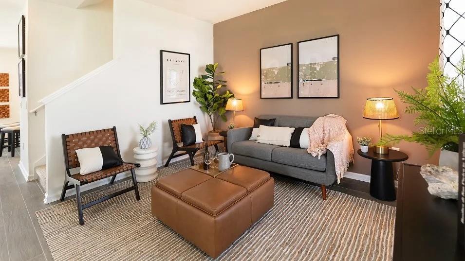 A living room features a gray sofa, two leather chairs, and a brown ottoman — 1955 STAKE OUT WAY, APOPKA, FL