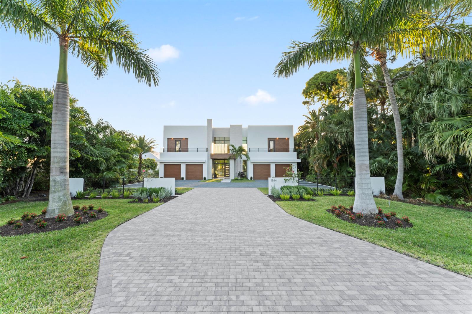 A modern two-story house with a paved driveway and palm trees in a tropical landscape — 1544 SE Saint Lucie Boulevard, Stuart FL 34996, STUART, FL