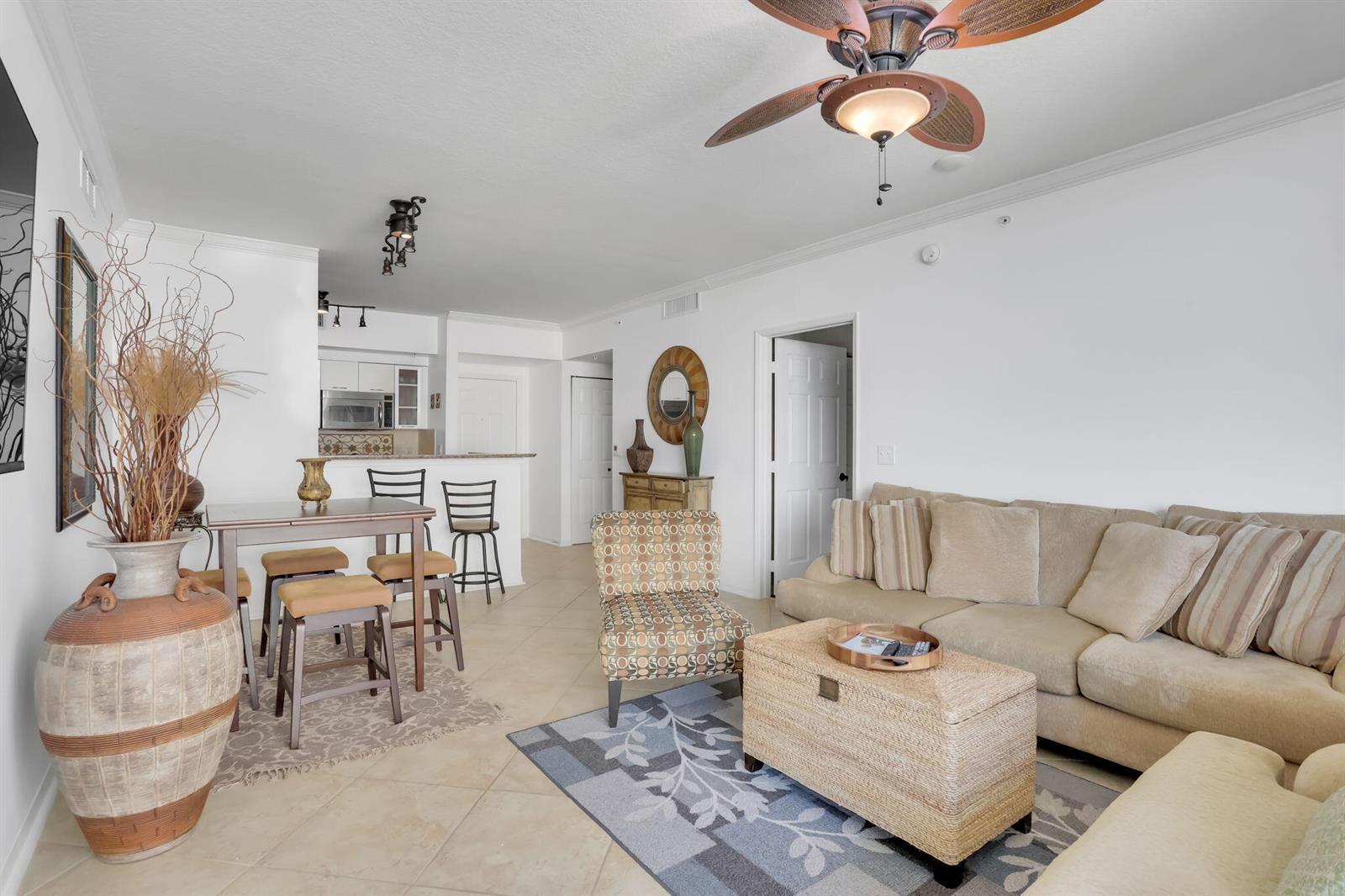 A living room and dining area with tile floors, a ceiling fan, and neutral furniture — 625 Casa Loma Boulevard # 1103, Boynton Beach FL 33435, BOYNTON BEACH, FL