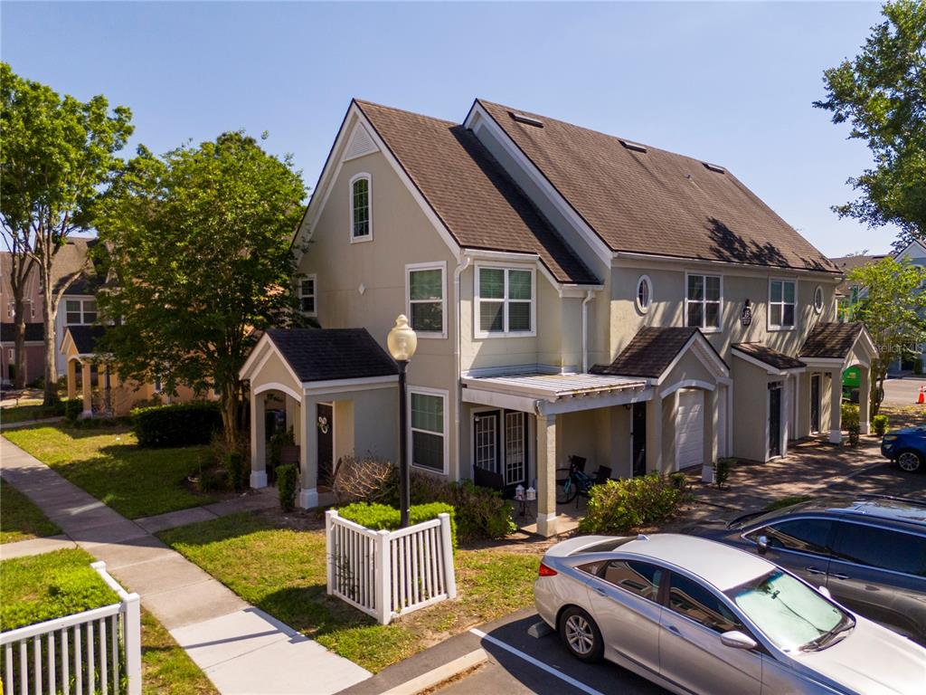 A two-story townhouse with a beige exterior, a brown roof, and a small front porch — 3353 WESTCHESTER SQUARE BOULEVARD UNIT 101, ORLANDO, FL