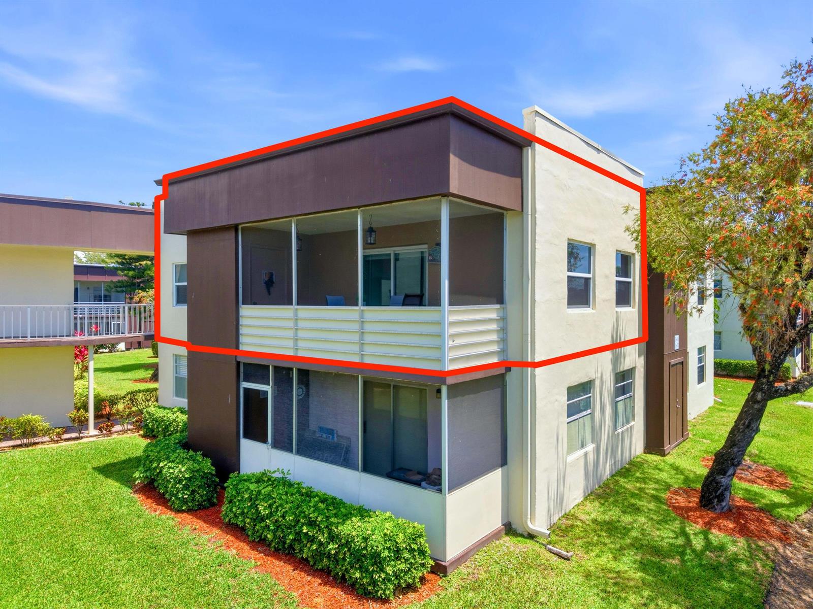 Exterior view of a two-story apartment building with a screened-in balcony on the upper level — 755 Normandy P, Delray Beach FL 33484, DELRAY BEACH, FL