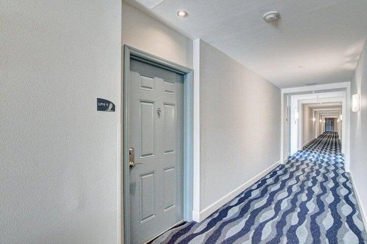 A gray door labeled LPH 9 sits in a hallway with patterned blue carpet — 625 Casa Loma Boulevard Unit 1, Boynton Beach FL 33435, BOYNTON BEACH, FL