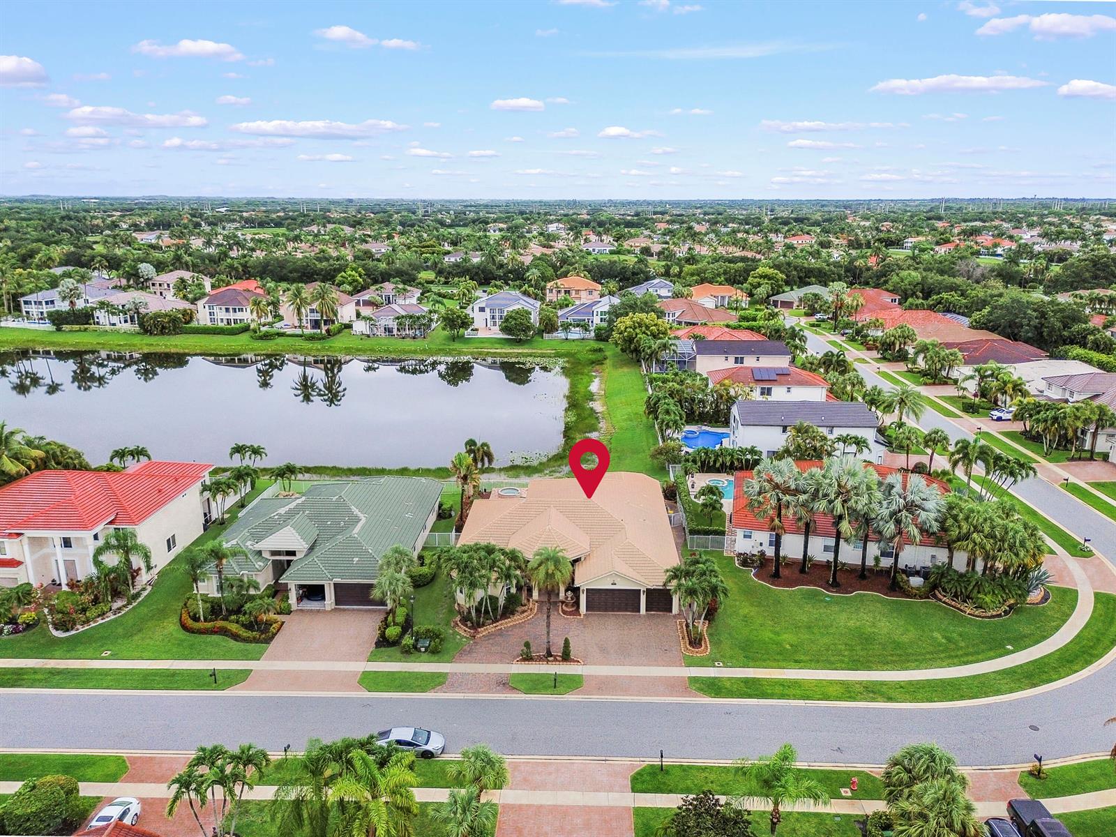 An aerial view shows a suburban house with a tan roof and a red map pin — 11852 Osprey Point Circle, Wellington FL 33449, WELLINGTON, FL