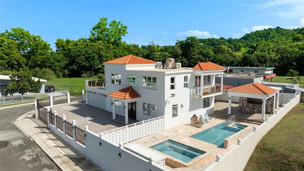 An aerial view of a two-story white house with a tiled roof, pool, and patio — Carr 411 Km 0.3 SECTOR RUIZ BO. CALVACHE, RINCON, PR
