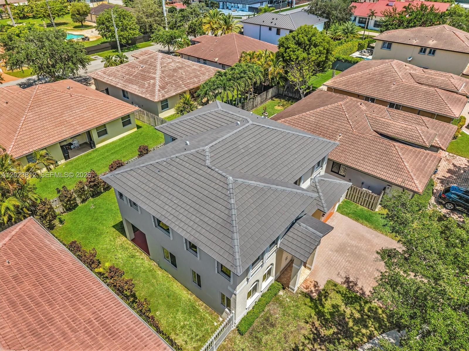 An aerial view shows a two-story gray house with a dark tiled roof and driveway — 2864 SW 138th Path, Miami FL 33175, MIAMI, FL
