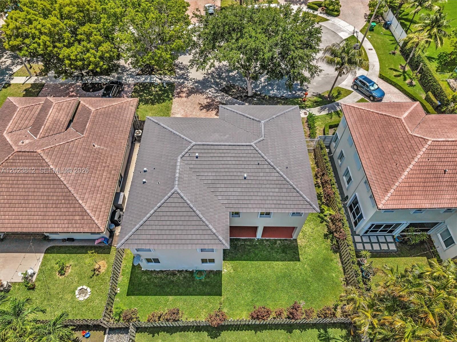 An aerial view shows the dark tiled roof of a house between two neighboring properties — 2864 SW 138th Path, Miami FL 33175, MIAMI, FL