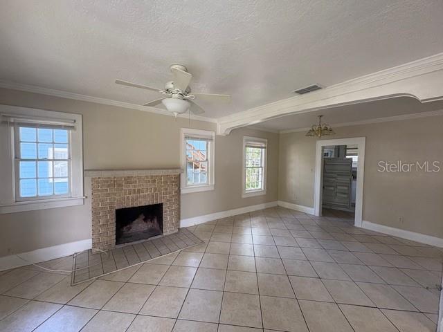A living room with a brick fireplace, tile flooring, a ceiling fan, and white trim — 714 WINFREE AVENUE, LAKELAND, FL