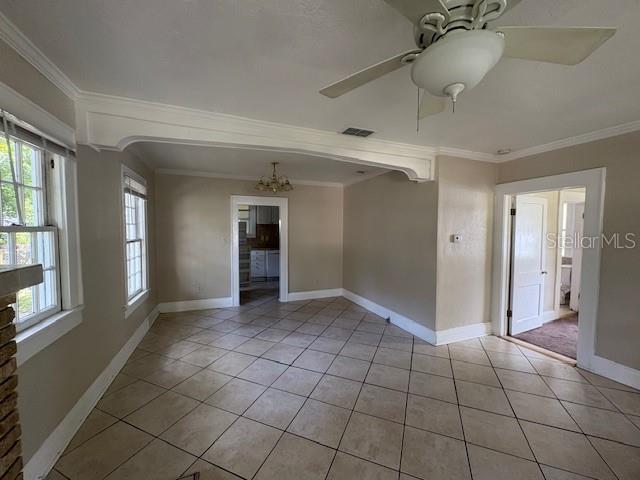 A room with beige walls, tiled floors, a ceiling fan, and doorways leading to other rooms — 714 WINFREE AVENUE, LAKELAND, FL