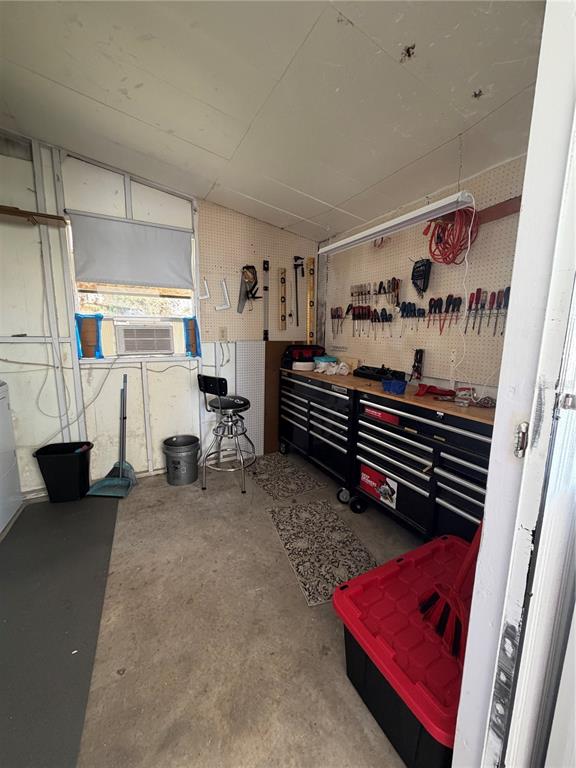 A workshop features a workbench with tool storage, a pegboard wall, and a stool — 520 MARNIE CIRCLE, MELBOURNE, FL