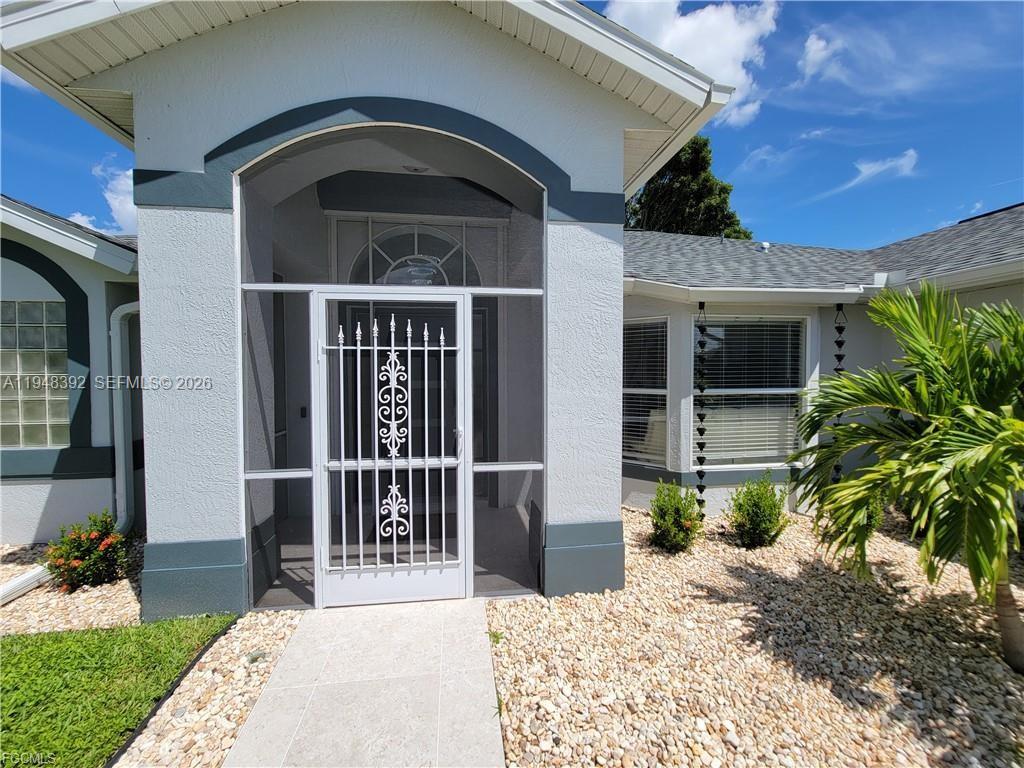 The exterior of a house features a covered entryway with a white security screen door — 237 SW 47TH ST # 0, Cape Coral FL 33914, CAPE CORAL, FL