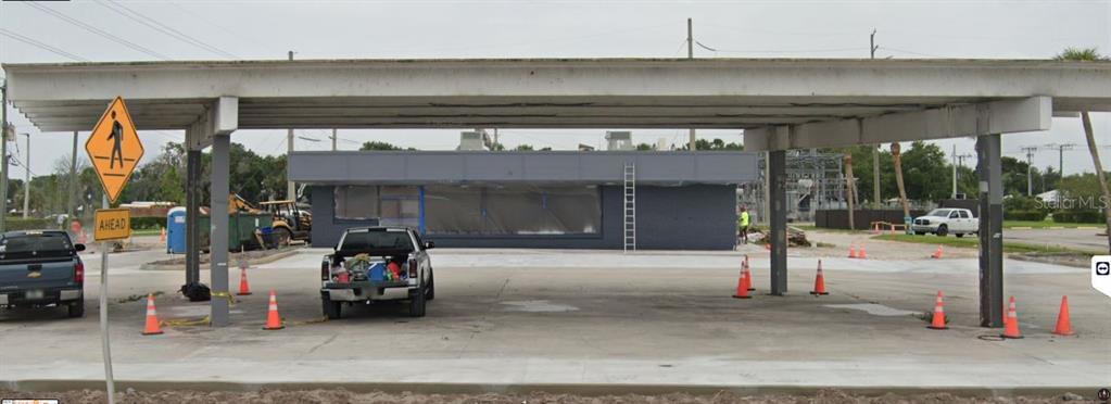 A commercial building with a large covered canopy and a parking lot under construction — 510 NE PARK STREET, OKEECHOBEE, FL