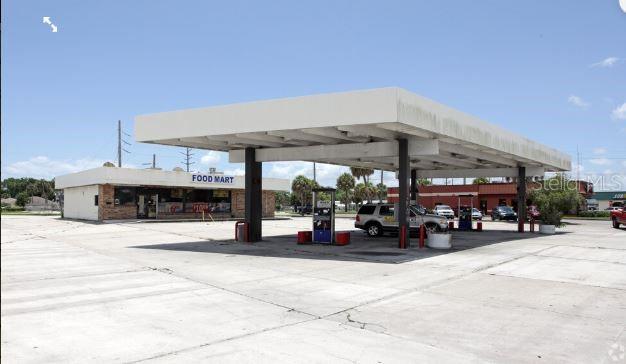 An exterior view of a gas station with a large canopy and a food mart building — 510 NE PARK STREET, OKEECHOBEE, FL