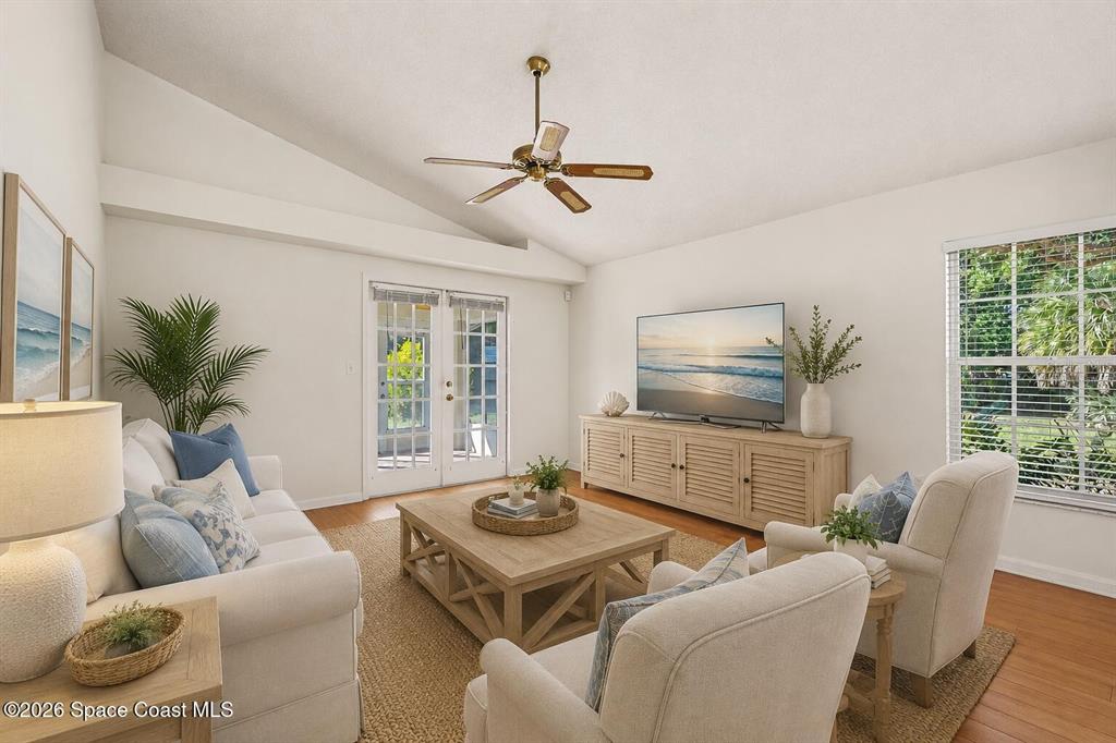 A living room features a vaulted ceiling, a ceiling fan, and a television console — 760 MONDAY COURT, COCOA, FL