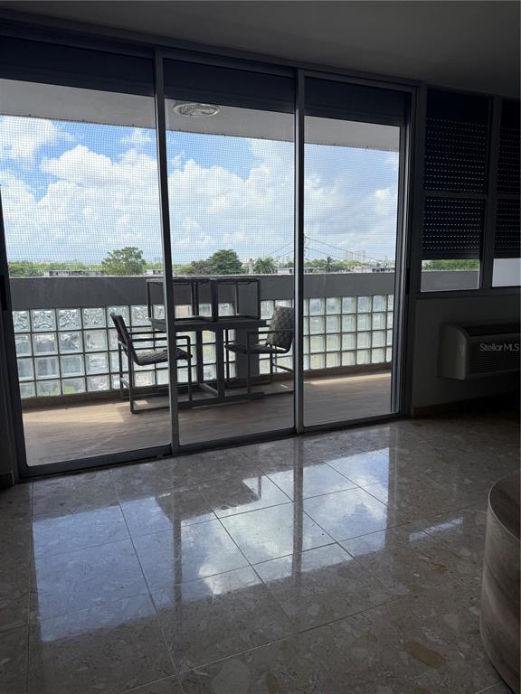 A room with tiled floors and a sliding glass door leading to a balcony — 3001 ave isla verde PLAZA DEL MAR UNIT 405, CAROLINA, PR