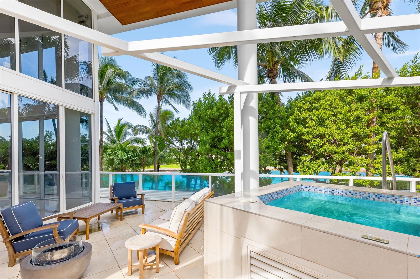 A patio features a small pool, outdoor seating, a fire pit, and views of palm trees — 1000 S Ocean Boulevard # 110, Boca Raton FL 33432, BOCA RATON, FL