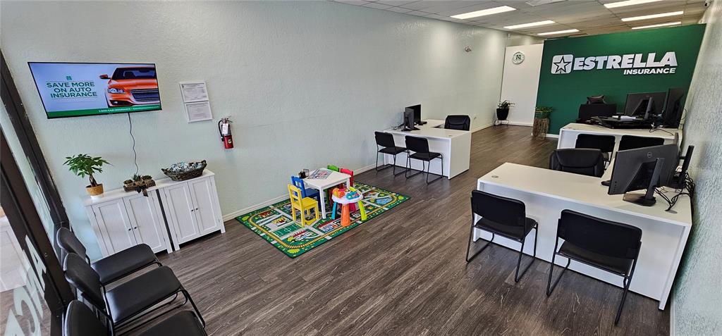 This insurance office features white desks, a children's play area, and a waiting area — 856 N NOVA, DAYTONA BEACH, FL