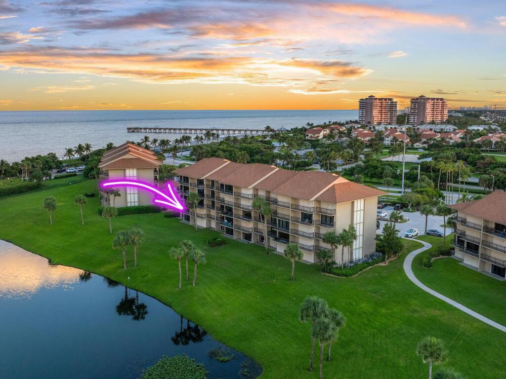 An aerial view of a multi-story residential building near a lake and the ocean — 601 S Seas Drive # 106, Jupiter FL 33477, JUPITER, FL
